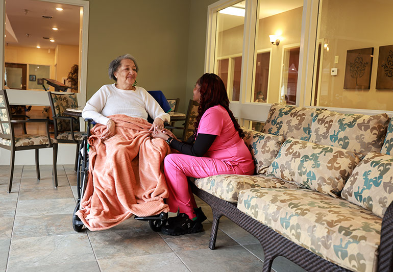 Resident and care team member talking together at Scottish Pines Rehabilitation & Nursing Center