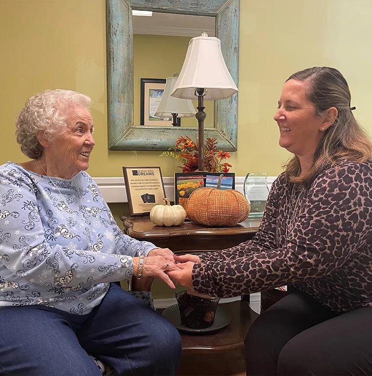 Speech-language pathologist working with a resident on communication skills