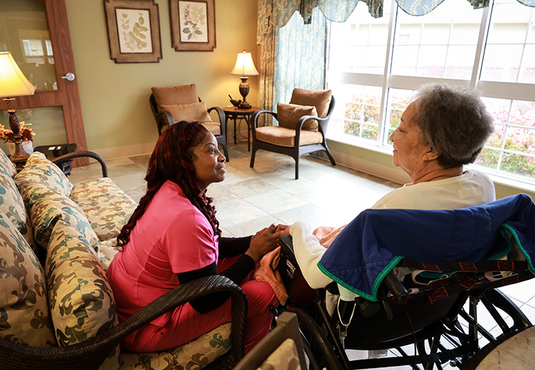 Therapist assisting a resident during a personalized speech rehabilitation session